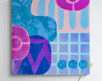 May include: Abstract painting with geometric shapes in shades of blue, purple, and pink. The painting is framed and hanging on a white wall above a table with a glass vase, a glass cup, a plate, and an orange.