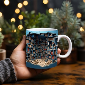 May include: A white ceramic mug featuring a blue and white design of a bookshelf overflowing with books. The bookshelf appears to be broken open, with books spilling out.