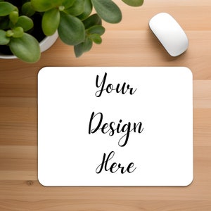 May include: White mouse pad with the text "Your Design Here" in black cursive font.