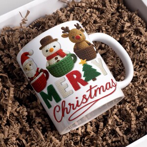 May include: White ceramic Christmas mug with a handle, featuring Santa Claus, a snowman, and a reindeer. The mug has the words "MERRY Christmas" in red and green, with a Christmas tree and star.