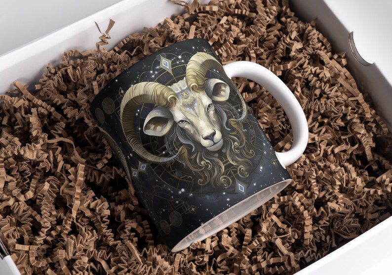 May include: A white ceramic mug with a black, gold, and white design of a ram's head with a starry background.