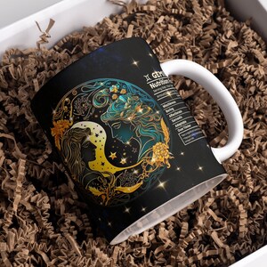 May include: A white ceramic mug with a black background and a gold and blue illustration of the Gemini zodiac sign. The mug has a handle and the text "Gemini Nutrition Facts" is printed on the side.