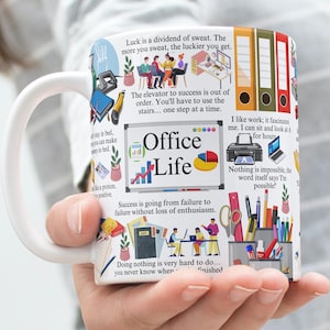 May include: White ceramic mug with a colourful design featuring office-themed illustrations and motivational quotes. The mug has a large handle and says "Office Life" in bold letters.