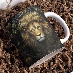 May include: White ceramic mug with a black and gold design featuring a lion's head with a celestial background.