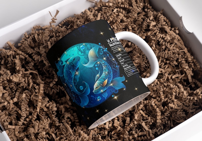 May include: A white ceramic mug with a black background and a blue and silver illustration of two fish. The text "*PISCES Nutrition Facts" is on the side of the mug.