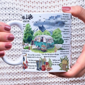 May include: White ceramic mug featuring a watercolour illustration of a camper van, mountains, and trees. The mug has text that reads "Van Life the Best Life" and several inspirational quotes about adventure and travel.