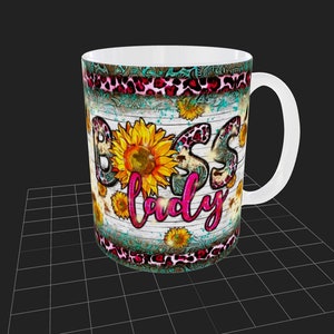 May include: White ceramic mug with a rustic wood background and a pink and black leopard print design. The mug features a sunflower and the text "Boss Lady" in pink glitter.