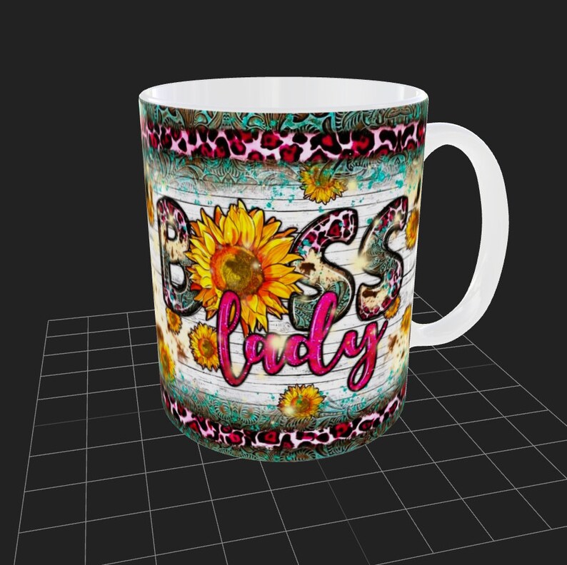 May include: White ceramic mug with a rustic wood background and a pink and black leopard print design. The mug features a sunflower and the text "Boss Lady" in pink glitter.