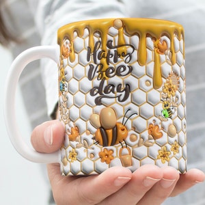 May include: White ceramic mug with a honeycomb pattern and dripping honey design. The mug has the text "Happy Bee Day" in black script. The mug features a 3D bee with yellow and black stripes.