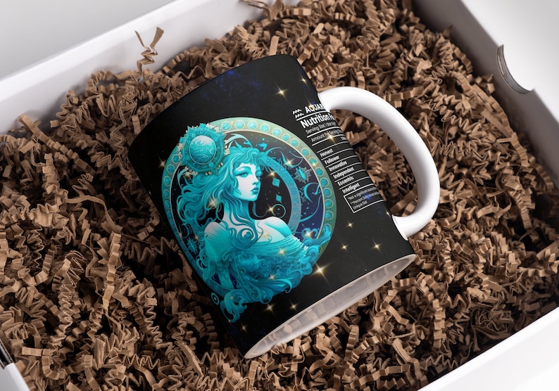 May include: A white ceramic mug with a black background and a blue and gold illustration of the astrological sign Aquarius. The mug has a white handle and the text "Aquarius Nutrition Facts" is printed on the side.