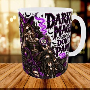 May include: A white ceramic mug featuring a graphic illustration of a skeleton wearing a witch hat and sunglasses, sitting in a chair with a black cat. The design includes purple smoke, bats, and the text "DARK MAGIC DON'T PANIC" with a "GOOD TROUBLE" potion.