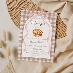 May include: A rectangular baby shower invitation card featuring a brown and white gingham border, a central illustration of a pie, and a pink ribbon graphic. The text reads: A little cutie pie is on the way! Join us for a baby shower honoring Clandia Smith, September 28th, Saturday at 4 PM, Rimberio Hall, 123 Anywhere St., Any City, ST 12345, RSVP to Claudia +123-456-7890.