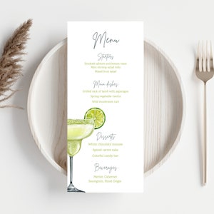 May include: A white menu card with a green lime margarita illustration. The menu lists starters, main dishes, desserts, and beverages. The text on the menu includes: Smoked salmon and lemon toast, Mini shrimp salad rolls, Mixed fruit salad, Grilled rack of lamb with asparagus, Spring vegetable risotto, Wild mushroom tart, White chocolate mousse, Spiced carrot cake, Colorful candy bar, Merlot, Cabernet, Sauvignon, Pinot Grigio.