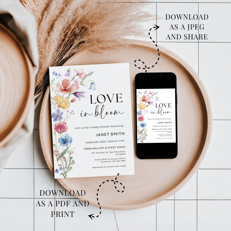 May include: A baby shower invitation with floral watercolor design. The invitation reads "LOVE in bloom" and includes event details. A smartphone displays the invitation. The invitation is on a wooden tray.