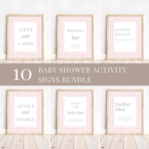 May include: A collection of six framed baby shower activity signs. Each sign features a pink and white gingham pattern and text such as "Gifts and Cards," "Mimosa Bar," and "Diaper Raffle." The signs are part of a 10-sign bundle.