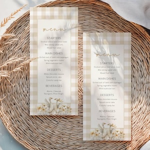 Puede incluir: Dos tarjetas de menú con un patrón a cuadros beige y blanco. Los menús enumeran entrantes, platos principales, postres y bebidas. La parte inferior de los menús presenta una ilustración de acuarela de gansos y flores. La palabra "menú" está escrita en cursiva.