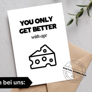 May include: A white greeting card with the text "YOU ONLY GET BETTER with age" and a cheese wedge illustration. The card is on a brown envelope, with a digital download stamp.