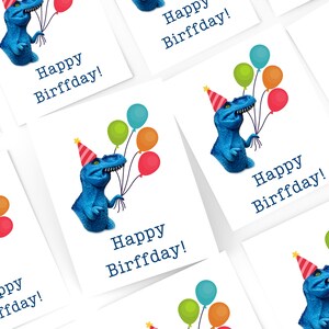 May include: White greeting cards featuring a blue dinosaur wearing a party hat and holding colorful balloons. The text "Happy Birffday!" is printed in dark blue. The cards are suitable for a birthday celebration.