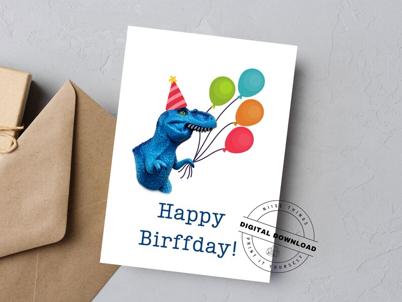 May include: A birthday card featuring a blue dinosaur wearing a party hat and holding colorful balloons. The card reads "Happy Birffday!" in dark blue text. A digital download stamp is in the corner.