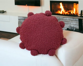 Coussin rond fait main à pompons bouclés bordeaux, décoration bohème