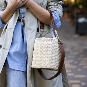May include: A set of three ceramic mugs with a speckled, matte finish. The mugs are in shades of cream, light gray, and dark gray. Each mug has a simple, minimalist design and a rounded handle.