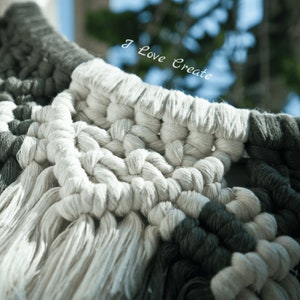 May include: Close-up of a white and gray macrame wall hanging with a fringe border. The macrame is made with thick cotton cord and has a geometric pattern. The text "I Love Create" is visible in the background.