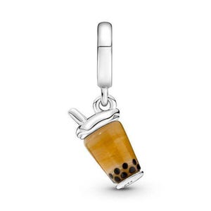 May include: Silver charm shaped like a boba tea cup with a straw. The cup is filled with a brown liquid and has black boba pearls.