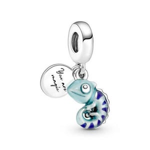 May include: Silver charm featuring a blue and purple enamel chameleon and a round charm inscribed with the words "You are magic".