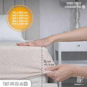 May include: Beige fitted sheet with dimensions listed: 90 x 200 cm, 140 x 200 cm, 160 x 200 cm, 180 x 200 cm, and 220 x 200 cm. The sheet depth is 25 cm (+/- 5 cm). The sheet is OEKO-TEX Standard 100 and CottonFast.