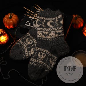May include: A pair of dark grey and off-white knitted socks featuring a repeating pattern of skulls, crescent moons, and bats. The socks have a ribbed cuff and a textured knit construction. A circular graphic overlay displays the text PDF ONLY.