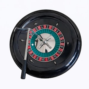 Antique black bakelite casino roulette wheel, roulette game with rake and vintage ball