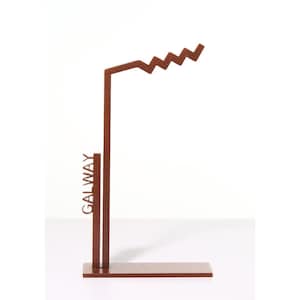 May include: A rusty brown metal stand with a zig-zag top and the word "GALWAY" on the side.