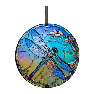May include: A stained glass style round ornament featuring a blue dragonfly with iridescent wings against a colorful background of blue, green, yellow, and purple.