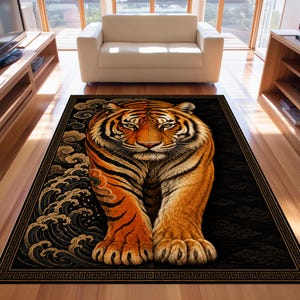 Könnte beinhalten: Ein rechteckiger Teppich mit einer großen, zentrierten Tigerillustration. Der Tiger ist orange und schwarz mit detaillierter Fellstruktur und befindet sich vor einem dunklen Hintergrund mit stilisierten Wellenmustern links und Wolken rechts.