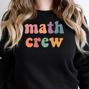 May include: Black sweatshirt with the text "math crew" in rainbow colors.