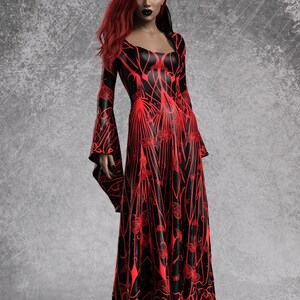 May include: A long, black dress with a red, intricate pattern. The dress features long, flared sleeves and a square neckline. The model has red hair and dark lipstick. The dress has a gothic or fantasy theme.
