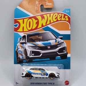 May include: A white 2018 Honda Civic Type R Hot Wheels toy car with blue and orange racing stripes. The car has a black front bumper and black wheels with orange rims. The car is on a blue and orange background with the words "Hot Wheels" in white.