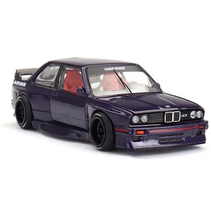 May include: A purple model car with black wheels and red interior. The car has a spoiler and the word "ADVAN" is visible on the side. The windshield has the text "KAIDA HOUSE".