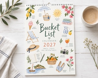 May include: A 2027 wall calendar titled Bucket List featuring watercolor illustrations of summer items including lemons, a beach umbrella, a sun, flowers, an ice cream cone, a deck chair, a straw hat, a notebook, a sailboat, a basket of oranges, and a camera.