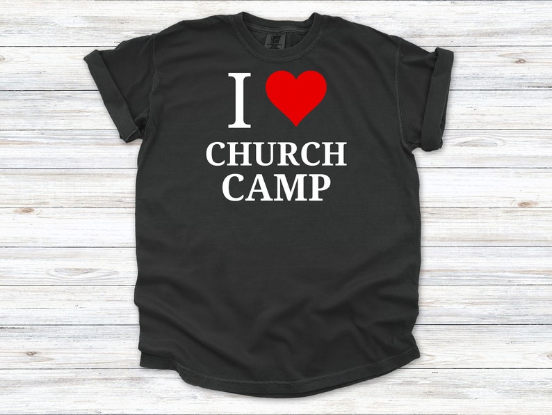 May include: Black t-shirt with white text that reads "I love church camp" and a red heart.