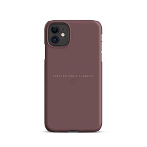 May include: A matte dark mauve phone case featuring the text "CREATED FOR A PURPOSE" in a clean, light-colored sans-serif font, positioned above a small, simple line-drawn heart icon centered on the back of the protective cover.