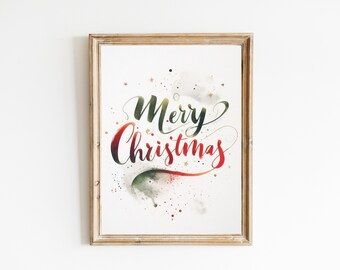 May include: A framed print with a watercolor design of the words "Merry Christmas" in green, red, and gold with a white background.