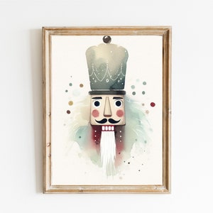 May include: Watercolor painting of a nutcracker soldier in a wooden frame. The artwork features a detailed depiction of the nutcracker's face, hat, and uniform, with a whimsical, artistic style. The color palette includes muted greens, reds, and browns.