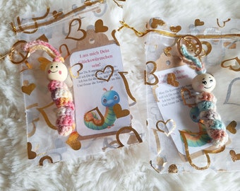 Lucky worm or lucky snail crocheted, with golden pendant, saying on card in small organza bag