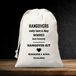 May include: White cotton drawstring bag with black text that reads "Hangovers only last a day Memories last forever Hangover Kit" with a black heart and the text "Markon & April 02.22.2023"