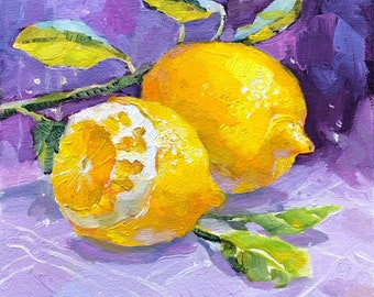 May include: Two yellow lemons with green leaves on a purple background. The lemons are slightly out of focus, and the leaves are in sharp focus.