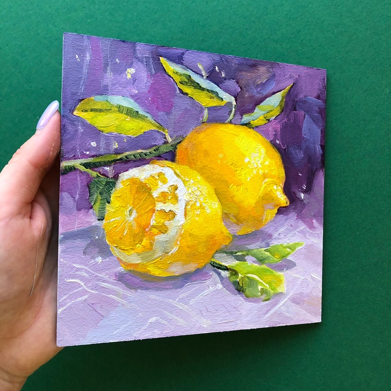 May include: Two yellow lemons with green leaves on a purple background. The lemons are painted in a realistic style with visible texture.