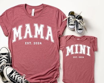 May include: Matching red t-shirt and bodysuit with white text. The t-shirt says "Mama Est. 2024" and the bodysuit says "Mini Est. 2024".