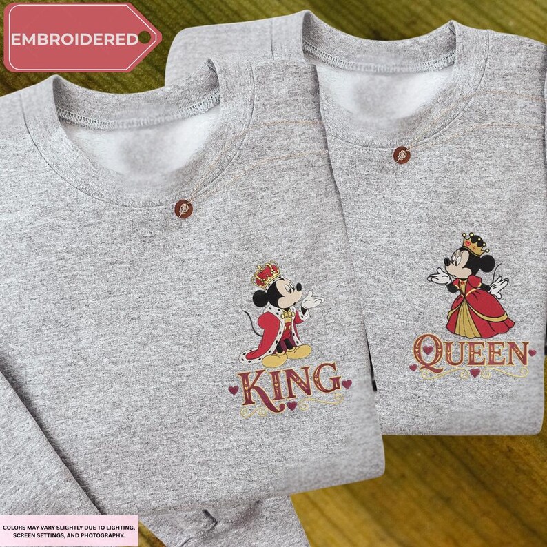 two gray sweatshirts with embroidered characters on them, including a king and a queen.