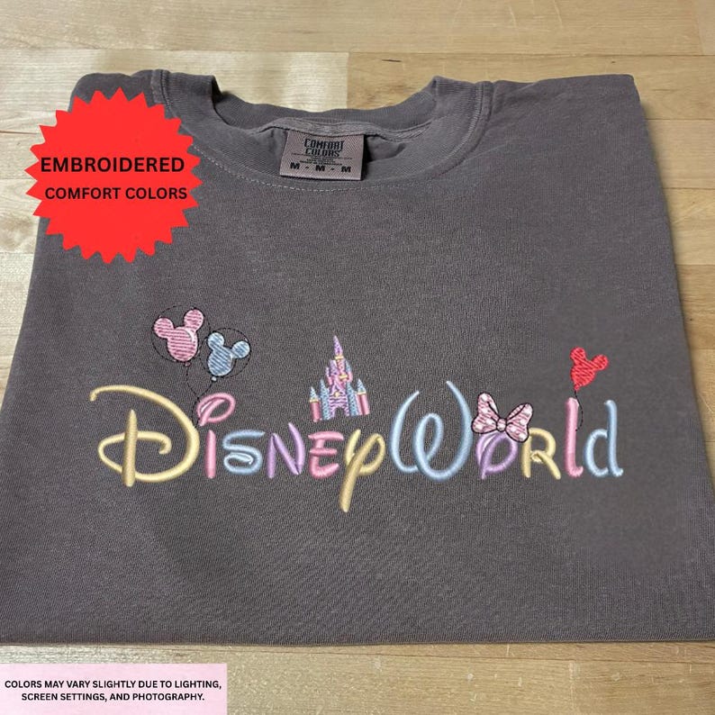 a gray t-shirt with the Disney World logo embroidered on it.